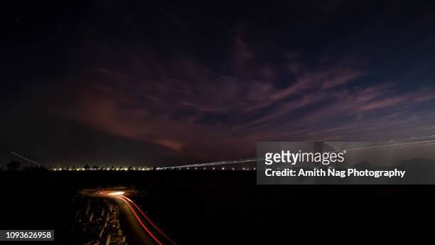 light-trails of approaching aircraft - bangalore stock pictures, royalty-free photos & images