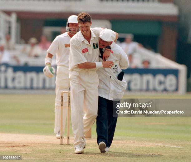 South African bowler Fanie De Villiers takes a lighthearted grip of umpire Dickie Bird watched by England batsman Alec Stewart during the 1st Test...