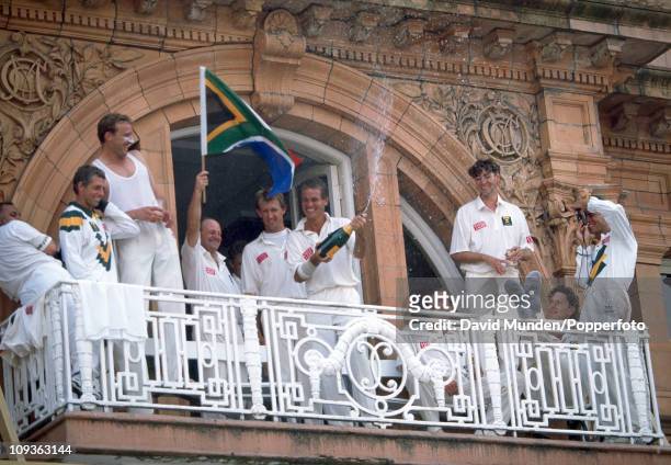 The captain of South Africa Kepler Wessels sprays champagne on the pavilion balcony as his team celebrate an historic victory in the 1st Test match...