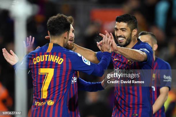 Luis Suarez of FC Barcelona celebrates his team's first goal with team mates Lionel Messi and Philippe Coutinho during the La Liga match between FC...