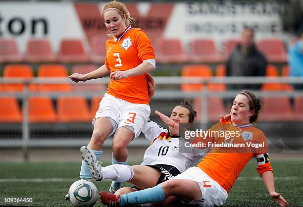 Kyra Malinowski of Germany and Desiree van Lunteren and Siri Worm of Netherlands compete for the ball during the women's international friendly match...