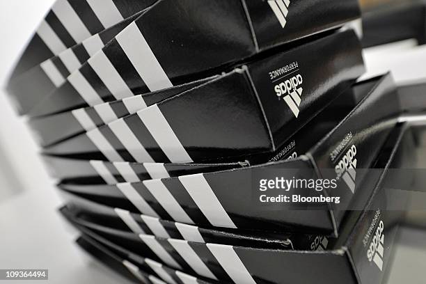Adidas AG branded shoe boxes sit on the production line at the company's factory in Scheinfeld, Germany, on Wednesday, Feb. 23, 2011. Adidas AG has...