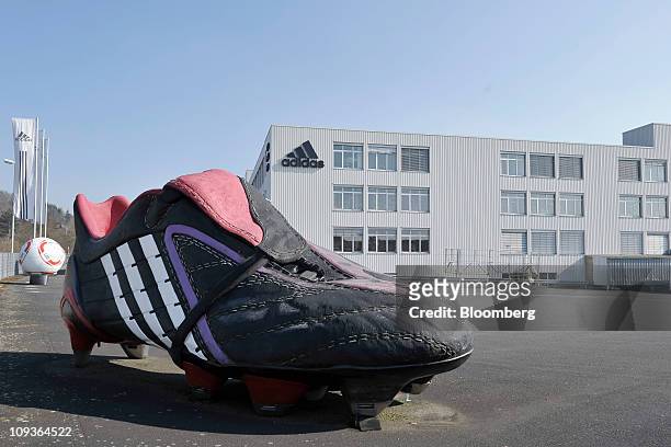 Model of an Adidas AG soccer shoe sits outside the company's factory in Scheinfeld, Germany, on Wednesday, Feb. 23, 2011. Adidas AG has extended its...