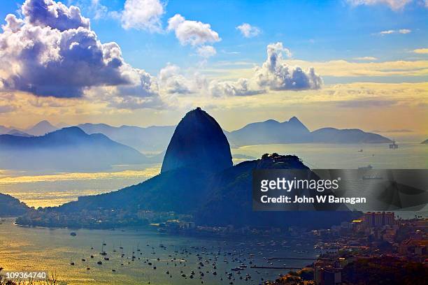 view of sugarloaf mountain and sea at sunrise - rio de janeiro aerial stock pictures, royalty-free photos & images