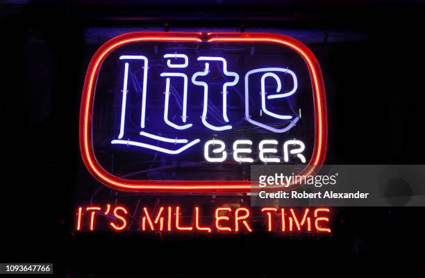 Neon sign advertising Miller Lite beer burns in the general store and bar at Luckenbach, Texas, an unincorporated community near Fredericksburg,...