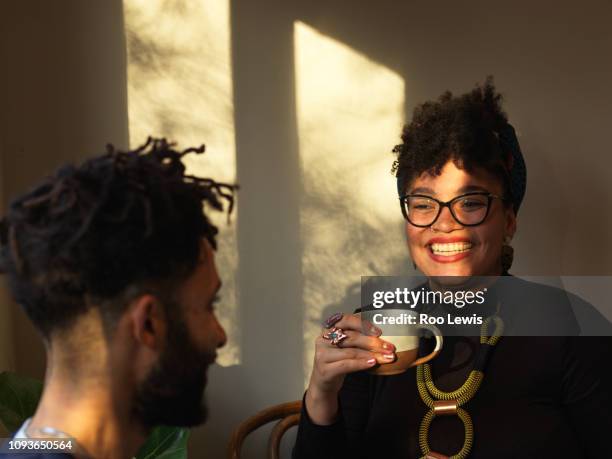 young couple having a coffee in dusk light - beards jewellery london stock-fotos und bilder