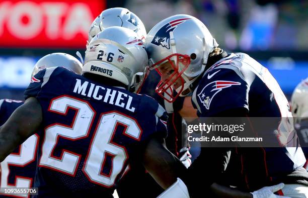 Sony Michel of the New England Patriots reacts with Tom Brady after scoring a touchdown during the first quarter of the AFC Divisional Playoff Game...