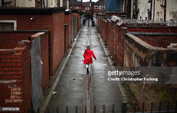 Young girl spends the half term school holiday playing in an an alleyway in the Gorton area of Manchester on February 23, 2011 in Manchester,...