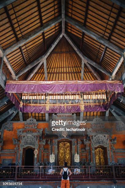 young woman looking at the temple in bali, indonesia - bali temples stock pictures, royalty-free photos & images