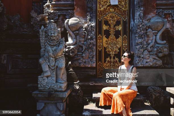 young tourist woman relaxing by the balinese temple - bali temples stock pictures, royalty-free photos & images