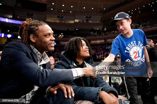 Young fan greets Latrell Sprewell, former Knicks guard, during the game between the New York Knicks and the Philadelphia 76ers at Madison Square...