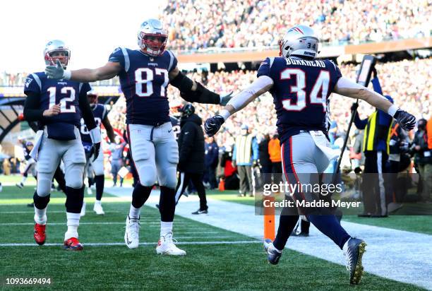 Rex Burkhead of the New England Patriots reacts with Rob Gronkowski and Tom Brady after scoring a touchdown during the second quarter in the AFC...