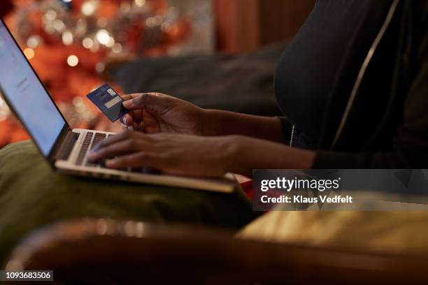 young woman ordering christmas gifts online - christmas budget stock pictures, royalty-free photos & images