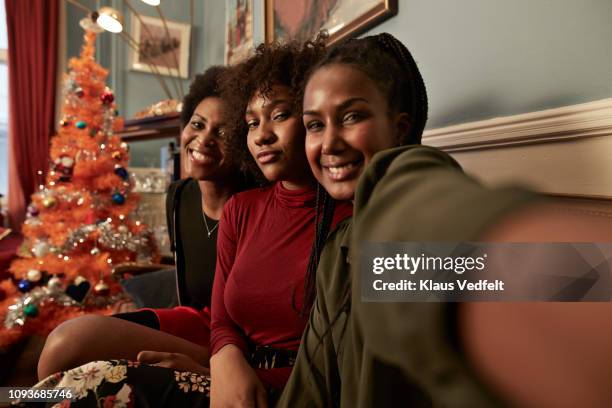 three young women making selfie in sofa at home - christmas selfie stock pictures, royalty-free photos & images