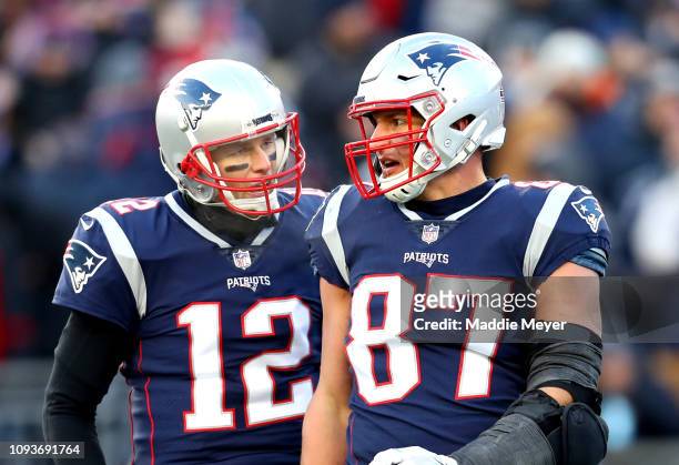 Tom Brady of the New England Patriots reacts with Rob Gronkowski during the third quarter in the AFC Divisional Playoff Game against the Los Angeles...