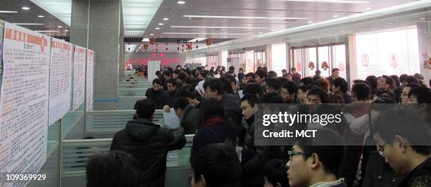 Applicants line up at a Foxconn recruitment booth in Zhengzhou, China, February 17, 2011.