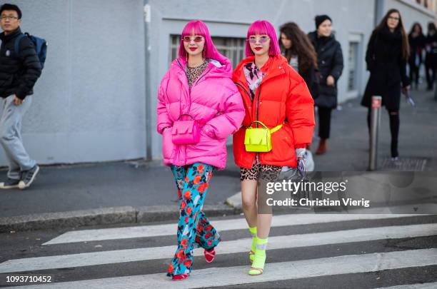 Twins with pink hair wearing pink down feather coat, belt bag seen outside MSGM during Milan Menswear Fashion Week Autumn/Winter 2019/20 on January...