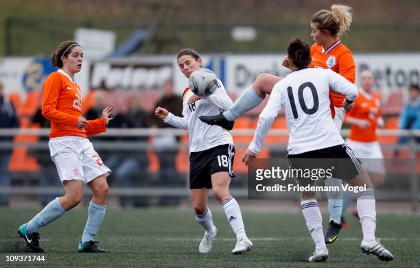 Anja Maike Hegenauer , Kyra Malinowski of Germany, Tessel Middag and Maud Roetgering of Netherlands compete for the ball during the Women's...