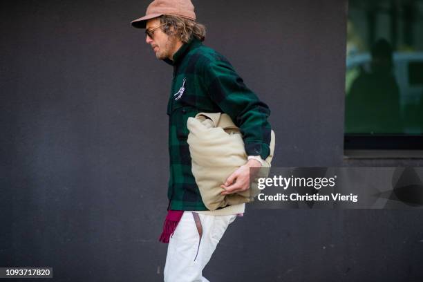 Guest is seen wearing green plaid jacket outside Sunnei during Milan Menswear Fashion Week Autumn/Winter 2019/20 on January 13, 2019 in Milan, Italy.