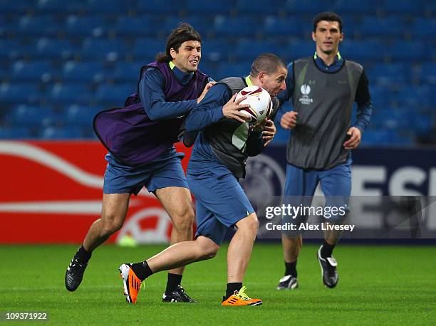 Sergio Koke of Aris Salonika is tackled by Juan Carlos Toja during a game of handball during a training session at City of Manchester Stadium on...