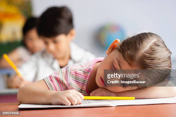 bored schoolgirl (4-5) sleeping in classroom - open day 4 stock pictures, royalty-free photos & images