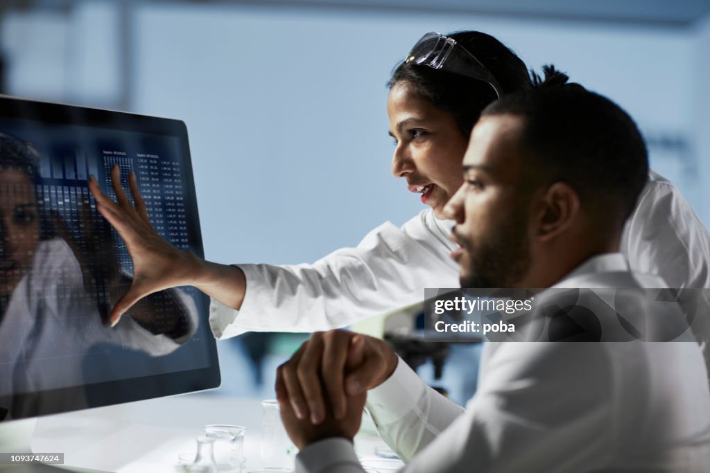 Scientists Working on Computer In  Modern Laboratory
