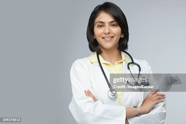 portrait of cheerful female doctor - indian doctors stock-fotos und bilder