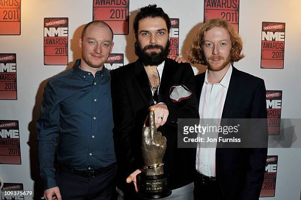 Ben Johnston , Simon Neil and James Johnston of Biffy Clyro pose with the award for 'Best Live Band' during the NME Awards 2011 at Brixton Academy on...