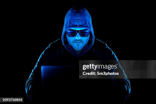 Hacker man with laptop stealing personal data from internet Hacker man with laptop stealing personal data from internet