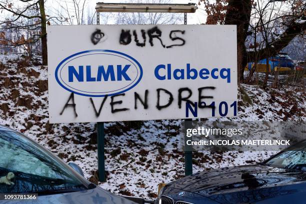 Illustration picture shows an NLMK sign with graffiti on it, reading 'A VENDRE', at a trade union post in front of the NLMK plant in Clabecq, Friday...