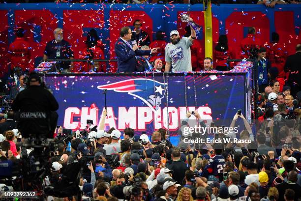 Super Bowl LIII: New England Patriots Julian Edelman victorious, holding up Vince Lombardi trophy during interview with CBS announcer Jim Nantz on...