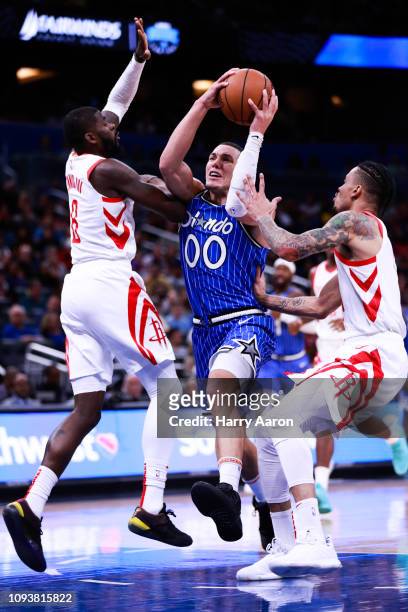 Aaron Gordon of the Orlando Magic tries to find an opening against James Ennis and Gerald Green of the Houston Rockets at Amway Center on January 13,...