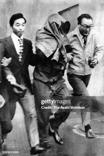 Soviet pilot Viktor Belenko, covering his face, is transferred to ...