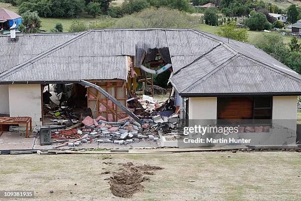 Large rolling rock destroys a house in Cass Bay, Lyttelton on February 24, 2011 in Christchurch, New Zealand. A massive search and rescue mission is...