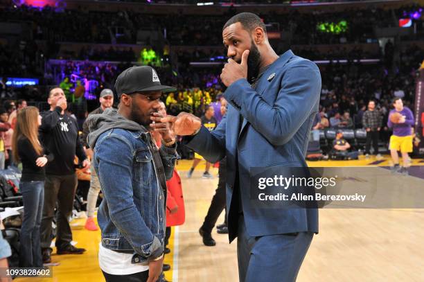 LeBron James talks to his agent Rich Paul during halftime of a basketball game between the Los Angeles Lakers and the Cleveland Cavaliers at Staples...