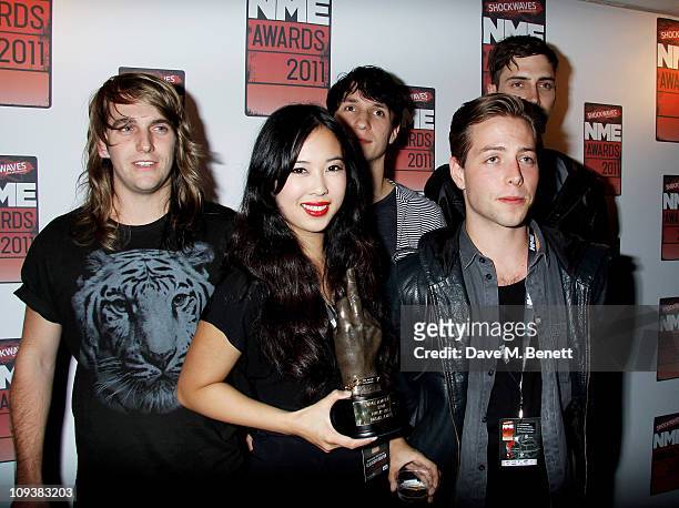 David Beadle, Thom Powers, Aaron Short, Jesse Wood and Alisa Xayalith of Naked and Famous pose against the Shockwaves NME Awards 2011 winners boards...