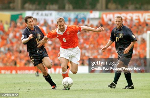 Ronald de Boer of the Netherlands breaks past John Collins and Billy McKinlay of Scotland during a UEFA Euro 1996 Group A match at Villa Park on June...