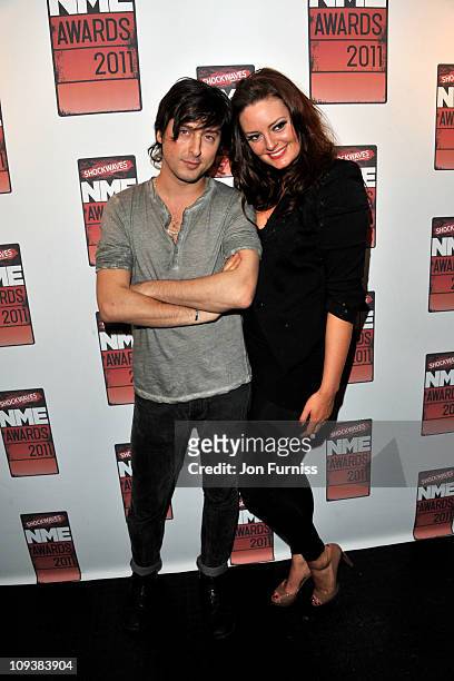 Carl Barat and guest pose in the press room during the NME Awards 2011 at Brixton Academy on February 23, 2011 in London, England.