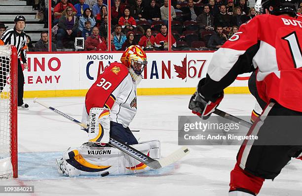 Scott Clemmensen of the Florida Panthers makes a pad save against Bobby Butler of the Ottawa Senators at Scotiabank Place on February 23, 2011 in...