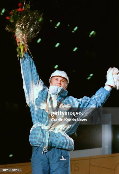 File photo shows Finnish ski jumping legend Matti Nykanen acknowledging the crowd after winning the 70-meter event at the 1988 Winter Olympics in...