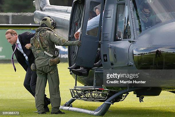 New Zealand Prime Minister John Key is helped from a RNZAF helicopter as he arrives at a Civil Defence Report Centre on February 24, 2011 in...