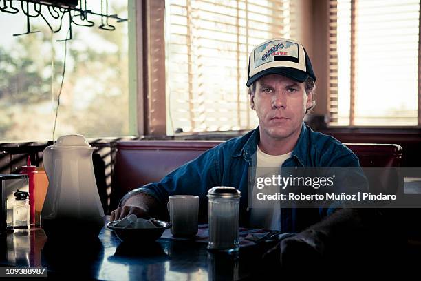 trucker is stares a camera - usa diner stock pictures, royalty-free photos & images