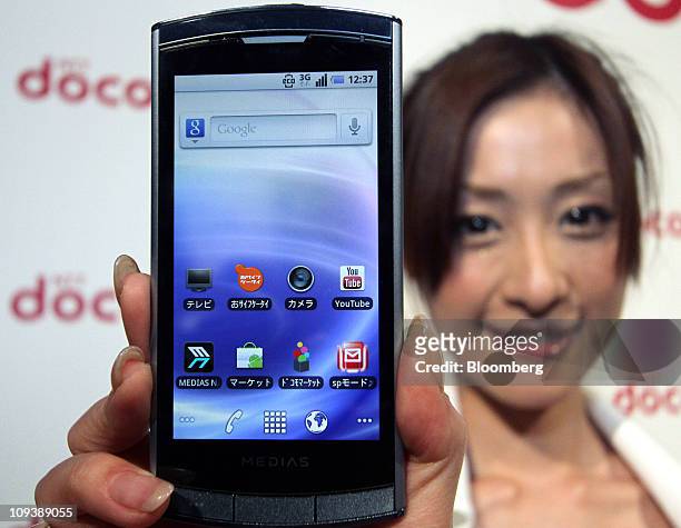 Model for NTT DoCoMo Inc. Shows off the Medias smartphone, manufactured by NEC Casio Mobile Communications Ltd., during an unveiling in Tokyo, Japan,...