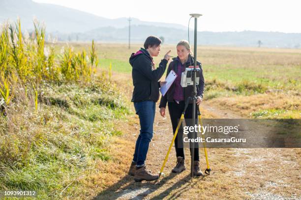 female surveyors discussing measurements - land surveyor stock pictures, royalty-free photos & images