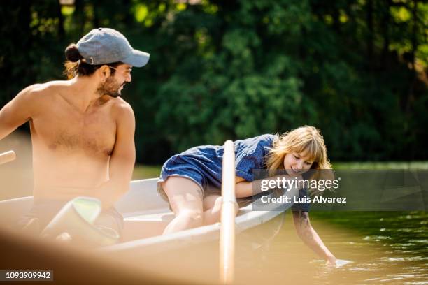 friends on rowboat in lake - couple see stock-fotos und bilder