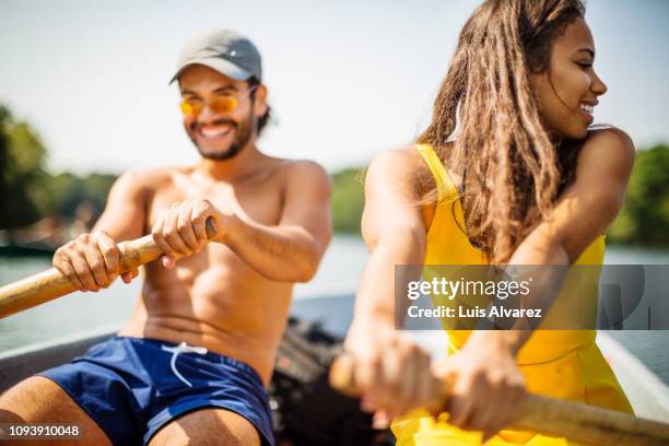 couple rowing a small boat on a lake - wonderlust stock pictures, royalty-free photos & images