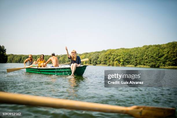 woman having fun on a boat ride with friends - see stock-fotos und bilder