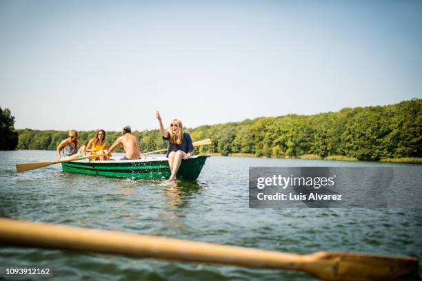 woman having fun on a boat ride with friends - emotion meer stockfoto's en -beelden