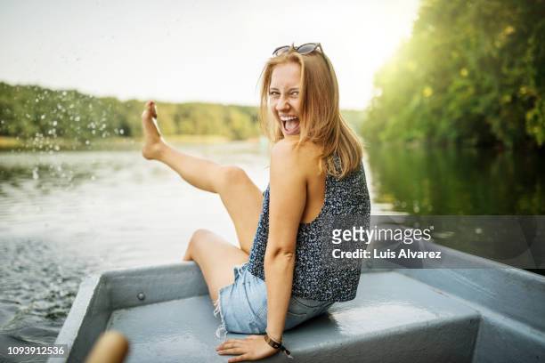 beautiful female on boat ride in lake having fun - sommer urlaub stock-fotos und bilder