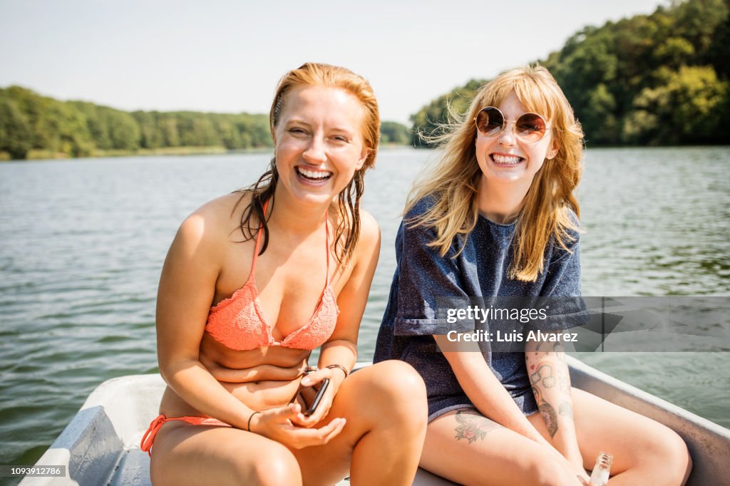 Friends enjoying a ride on boat in lake